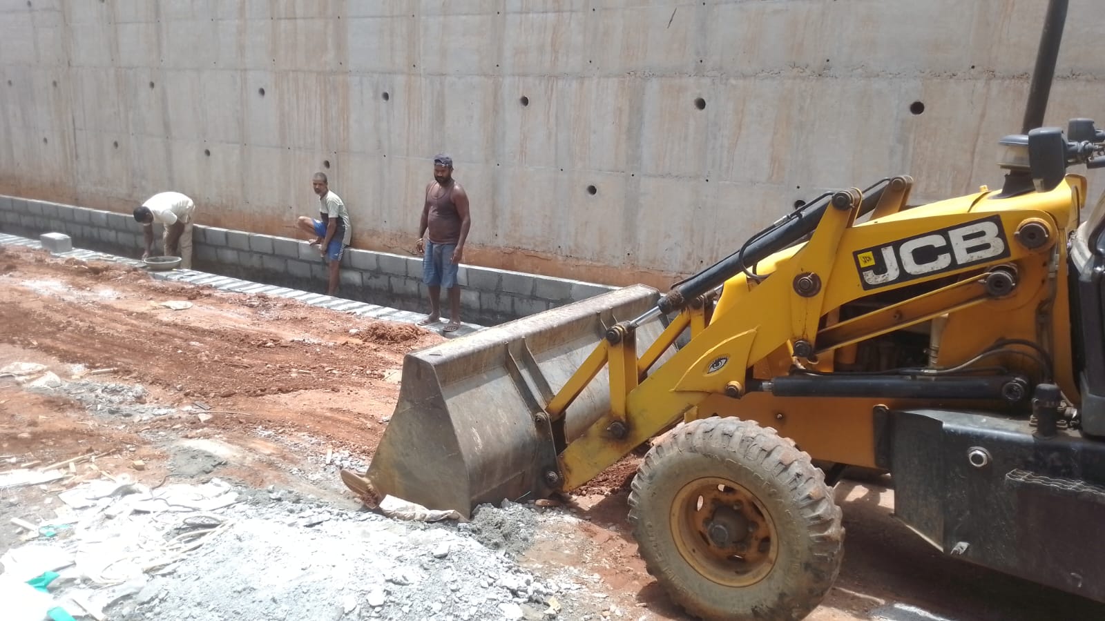 Retaining wall side drain construction with masonry work